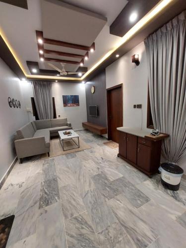 a living room with a couch and a table at Cozy 2-Bed Portion at Gulshan Iqbal blk 7 in Karachi