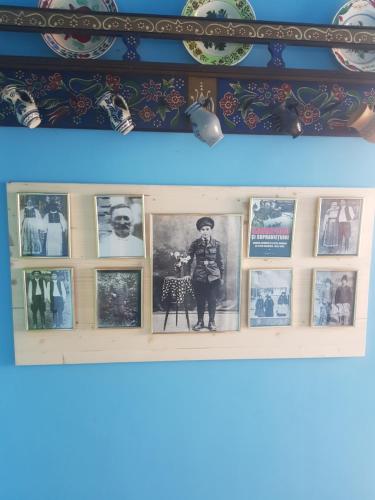 a shelf with pictures of a boy on it at Casa La Casiru in Straja