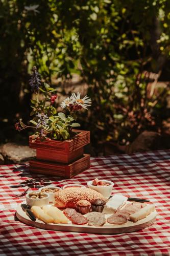 a table with a plate of food on a table at Recanto Vó Eni in Gramado