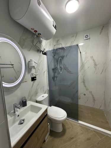 a bathroom with a shower and a toilet and a sink at Three Brothers in Široka