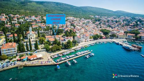 an aerial view of a city with boats in the water at Apartments Cindrić in Selce