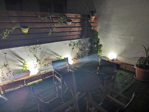 a patio with chairs and a table with lights at Tsitsipas Apartment in Alexandroupoli