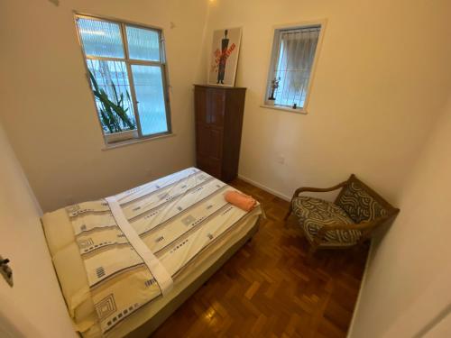 a small bedroom with a bed and a window at Apartment in IPANEMA in Rio de Janeiro