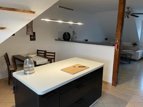 a kitchen with a white counter top and a table at Bambus, Jungle, Dachterrasse & bequem bis Zentrum in Radebeul