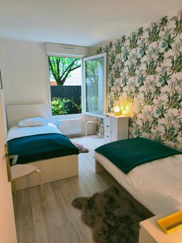 une chambre avec deux lits et une fenêtre dans l'établissement Neuf, calme, 10 minutes du centre de Paris, à Saint-Denis