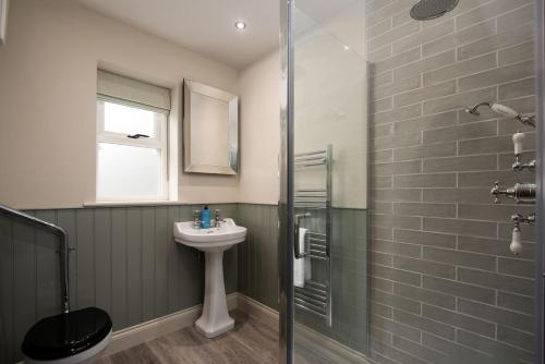 a bathroom with a sink and a shower at Risingham House in West Woodburn