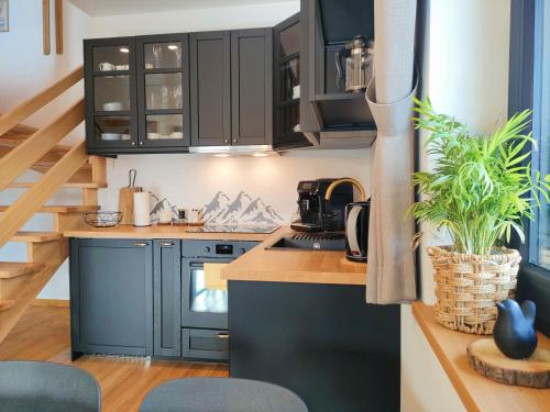 a kitchen with blue cabinets and a counter top at Domki Hygge Tatra Luxury Chalet in Murzasichle