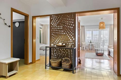 a living room with a wall with polka dots at Unirii Green Apartment in Bucharest