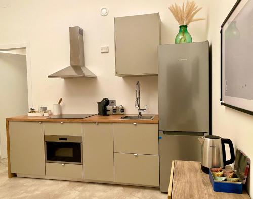 a kitchen with a refrigerator and a sink at La Cadrega in Milan