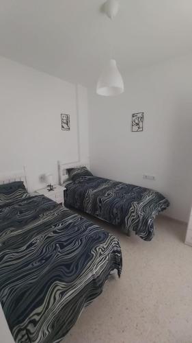Postel nebo postele na pokoji v ubytování Brisas del Guadalquivir