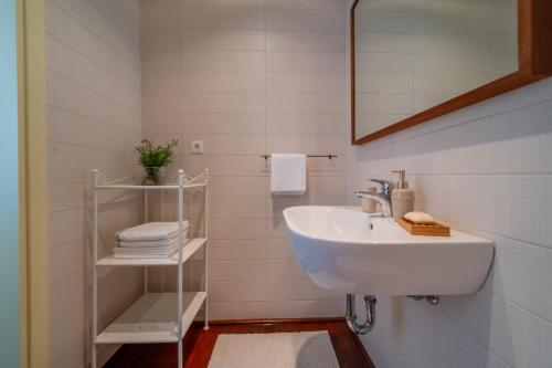 uma casa de banho branca com um lavatório e um espelho em Old Town Seabreeze Residence em Rovinj