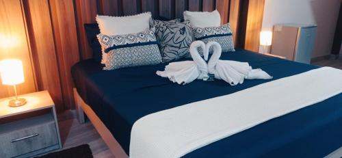 a bedroom with a blue bed with pillows at RENTSUITE Los Pinos 165 in Tarapoto