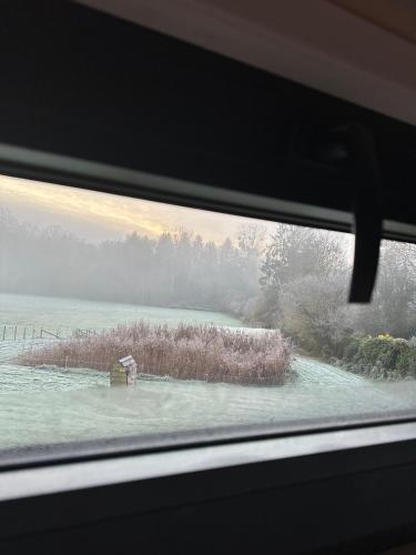 a view of a field from a car window at Joy Tiny House Perche in Madeleine