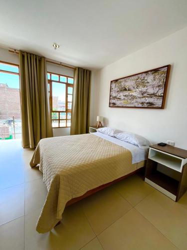 a bedroom with a large bed and a window at El Huerto Hostel in Ica