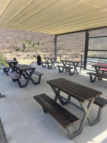 a group of picnic tables sitting under a tent at Mavrovo Square One Bedroom APARTMENT in Mavrovo