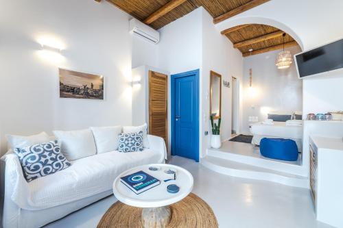 a living room with a white couch and a table at Chiara Mykonos in Mýkonos City