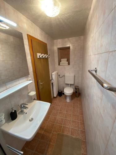 a bathroom with a sink and a toilet at Rosenheim Apartments in Tires