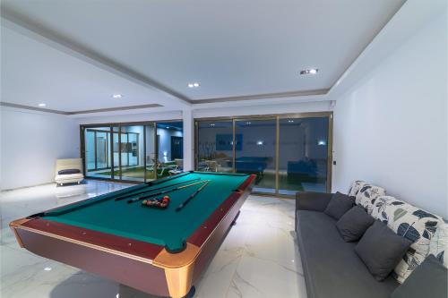a living room with a pool table and a couch at Villa Monarca in Costa Teguise