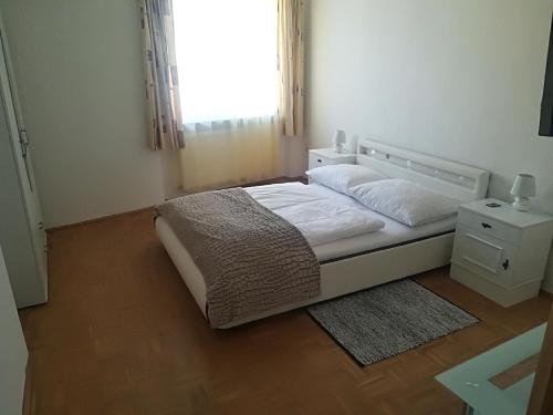 a bedroom with a bed with a window and a rug at Ferienhaus für 10 Personen in Ulrichsberg, Oberösterreich Mühlviertel in Ulrichsberg