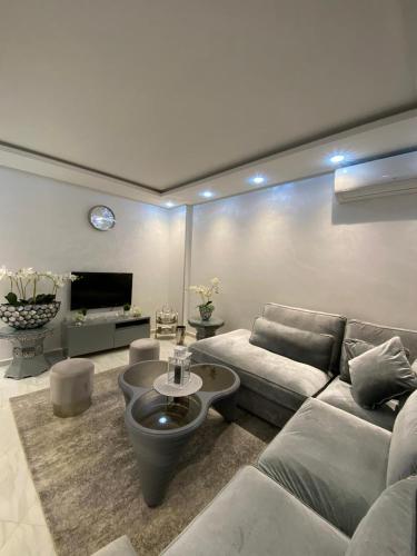 a living room with a couch and a table at Mini villa 1 Al hoceima in Al Hoceïma