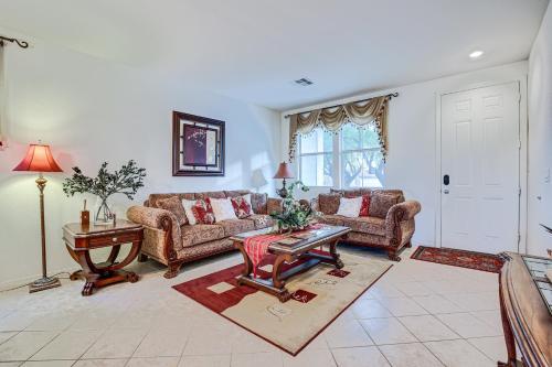 a living room with two couches and a table at Las Vegas Home with Mtn Views 13 Mi to the Strip! in Las Vegas