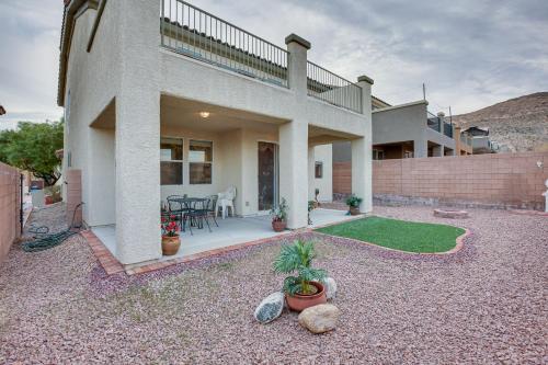 a house with a patio with a table and chairs at Las Vegas Home with Mtn Views 13 Mi to the Strip! in Las Vegas