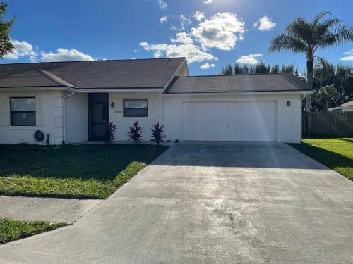 a house with a garage and a driveway at Sunny Jupiter Villa in Jupiter