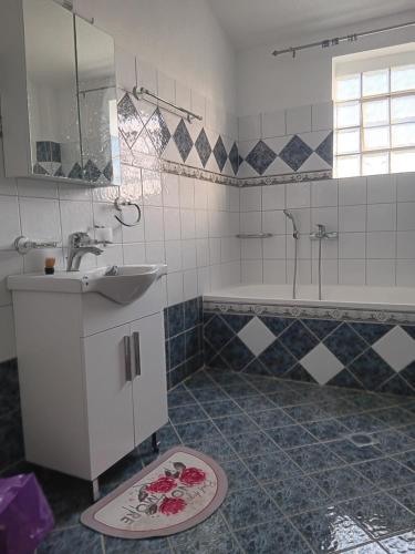 a bathroom with a sink and a bath tub at Babis House in Limenaria