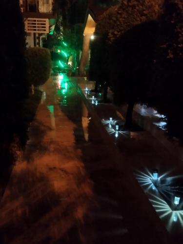 a street at night with lights on the sidewalk at Pınar Vintage House in Pamukkale