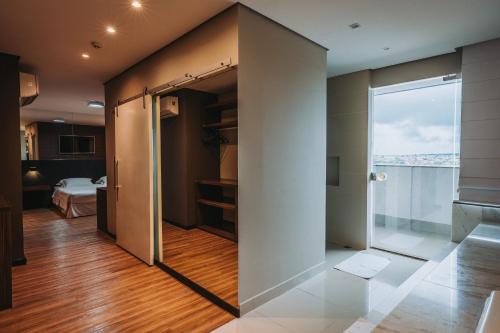 a room with a sliding glass door with a window at Catuai Hotel in Cacoal