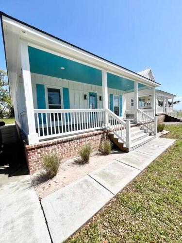 a home with a large porch with white rails at Coastal Oasis in Gulfport