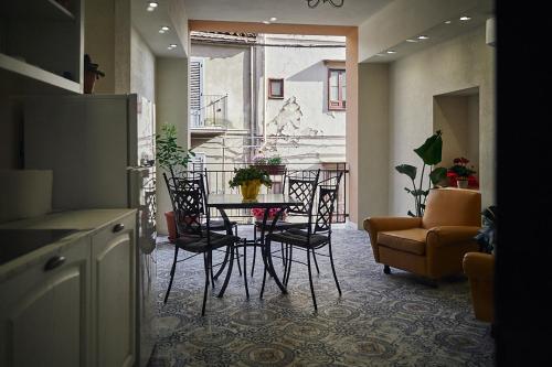 a living room with a table and chairs and a couch at Trinacria Caccamo - Luxury Rooms in Caccamo