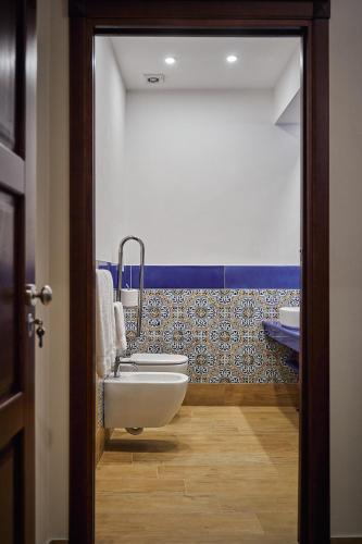 a bathroom with a sink and a bath tub at Trinacria Caccamo - Luxury Rooms in Caccamo