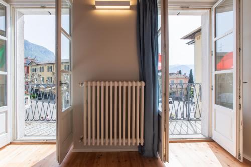 a radiator in a room with windows at Albergo Del Sole in Varenna