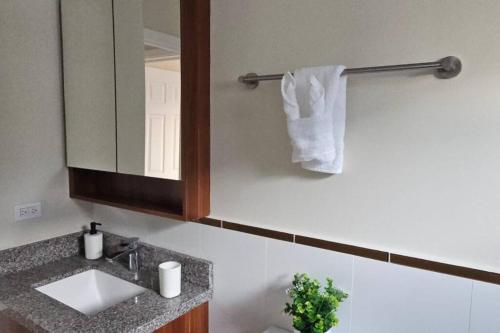 a bathroom with a sink and a mirror and a towel at Ocean Blue Villa in Lucea in Point