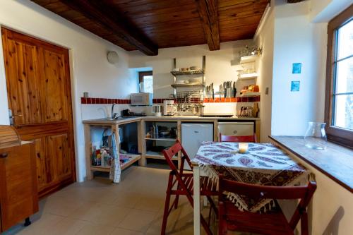 a kitchen with a table and a counter top at Poklidná Chalupa in Klenovice