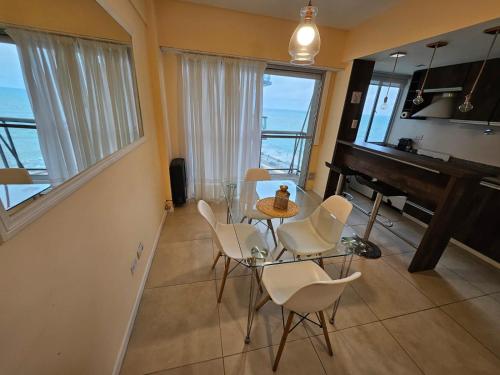 a living room with a table and a piano at Hermoso 2 ambientes en la costa con vista al mar in Mar del Plata