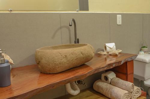 a stone sink on a counter in a bathroom at GLAMPING MINDO SUYANA in Mindo