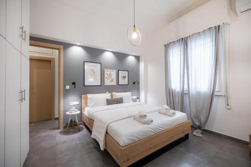 a bedroom with a large bed and a window at Ports Crossroad C in Piraeus