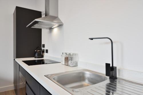 a kitchen with a stainless steel sink and aaucet at Apt 1, 15 West Street in Hereford
