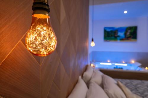 a light bulb hanging over a bed in a room at Le Querce Farmhouse in Agropoli