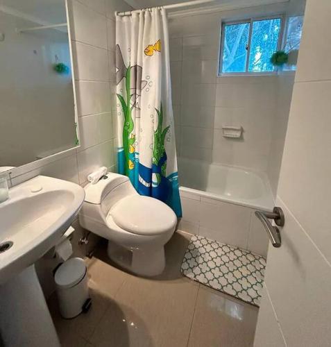 a bathroom with a toilet and a sink and a shower at Hermoso Depto. Santo Domingo in Santo Domingo