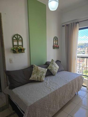 A bed or beds in a room at Hospedagem Flat verde Sul de Minas