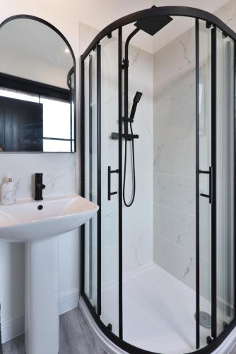 a bathroom with a shower and a sink at Apt 2, 15 West Street in Hereford
