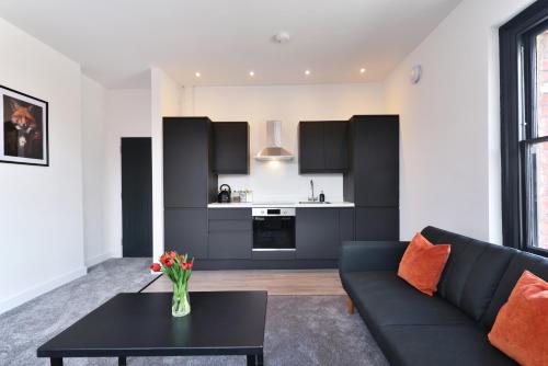 a living room with a couch and a table at Apt 2, 15 West Street in Hereford
