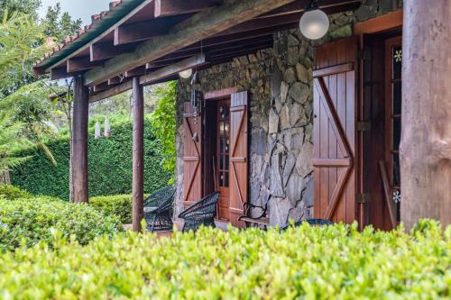an entrance to a stone house with a wooden door at Villa Achada da Mouca by Homie in Santana