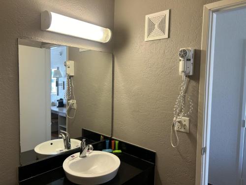a bathroom with two sinks and a mirror at Motel 6-Stanton, CA- Anaheim West in Stanton