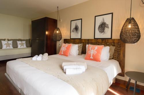 a bedroom with a large bed with towels on it at Les Villas du Lagon in Le François