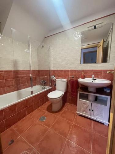 a bathroom with a toilet and a sink at Villa Giraldillo in Colunga