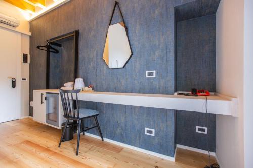 a kitchen with a counter and a chair in a room at Albergo Del Sole in Varenna